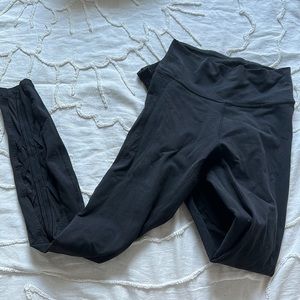 Black Lululemon leggings with criss cross on bottom of legs